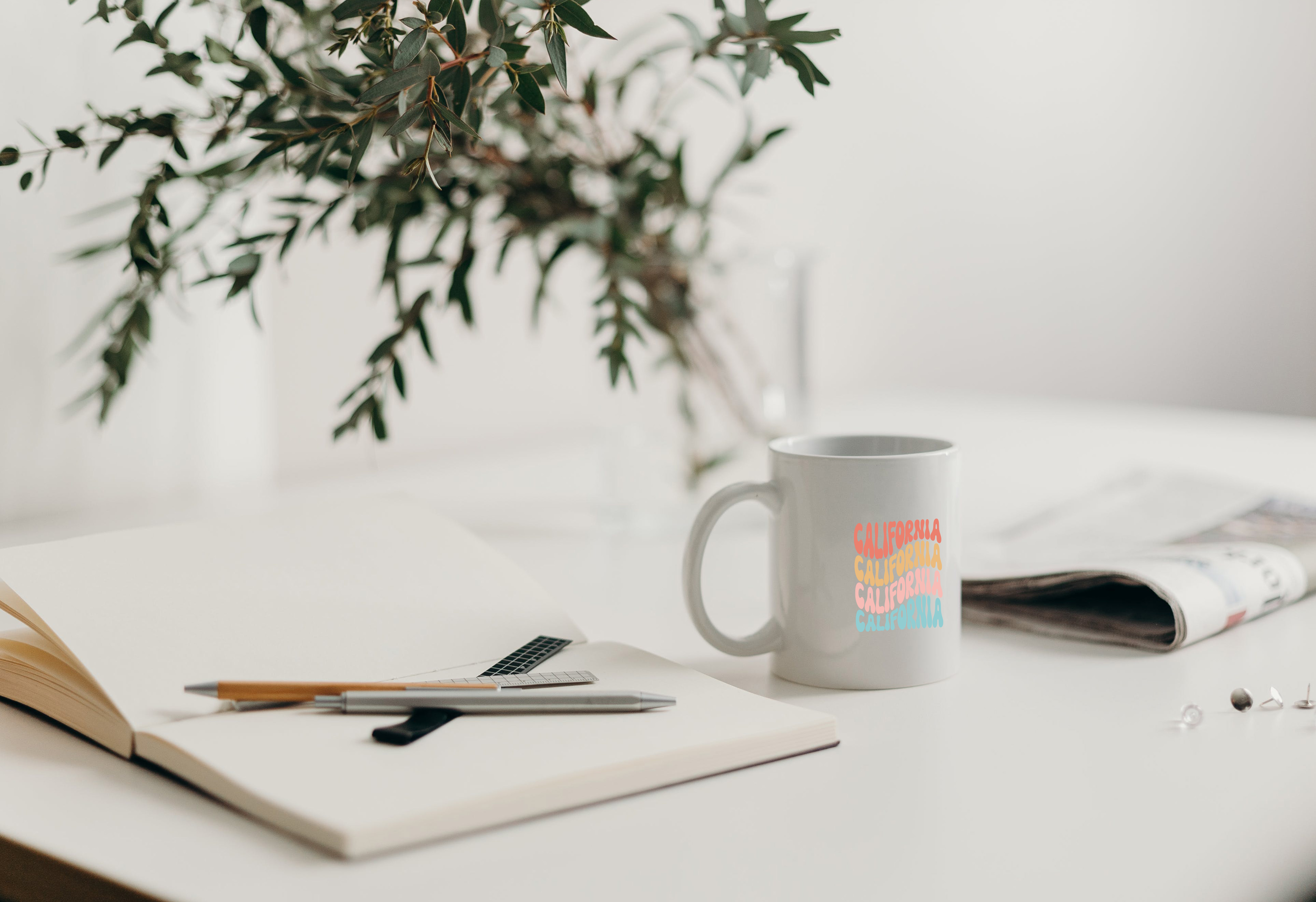 Custom printed mug on desk next to notebook